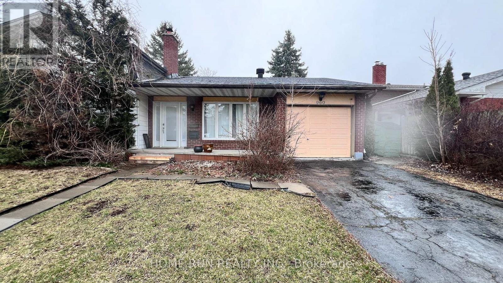 A house with a brown garage door and a white door.