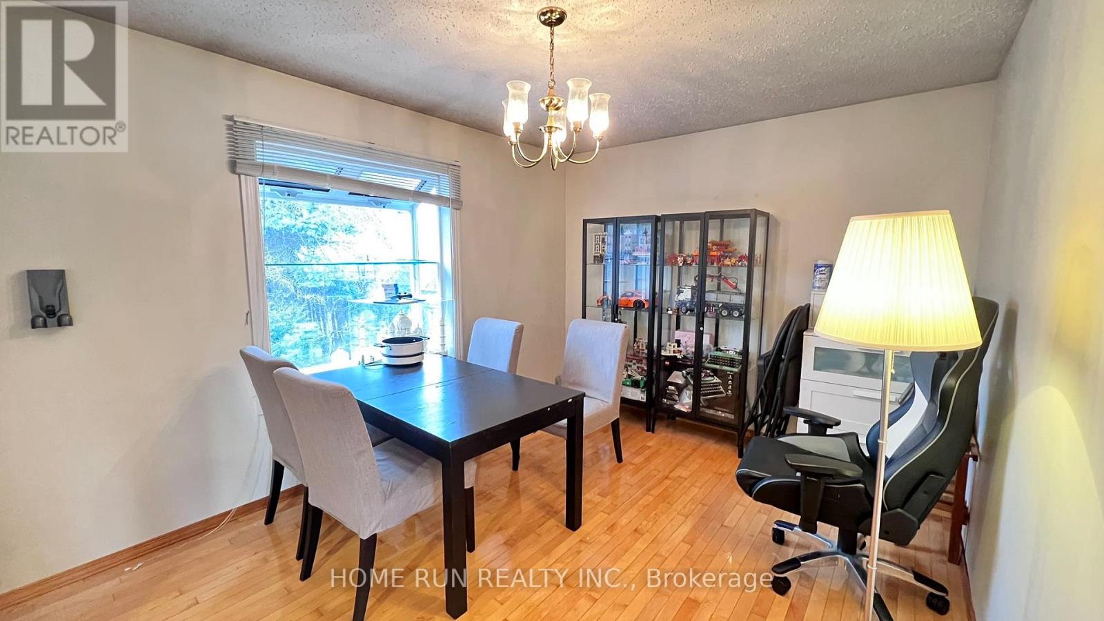 A dining room with a table and chairs.