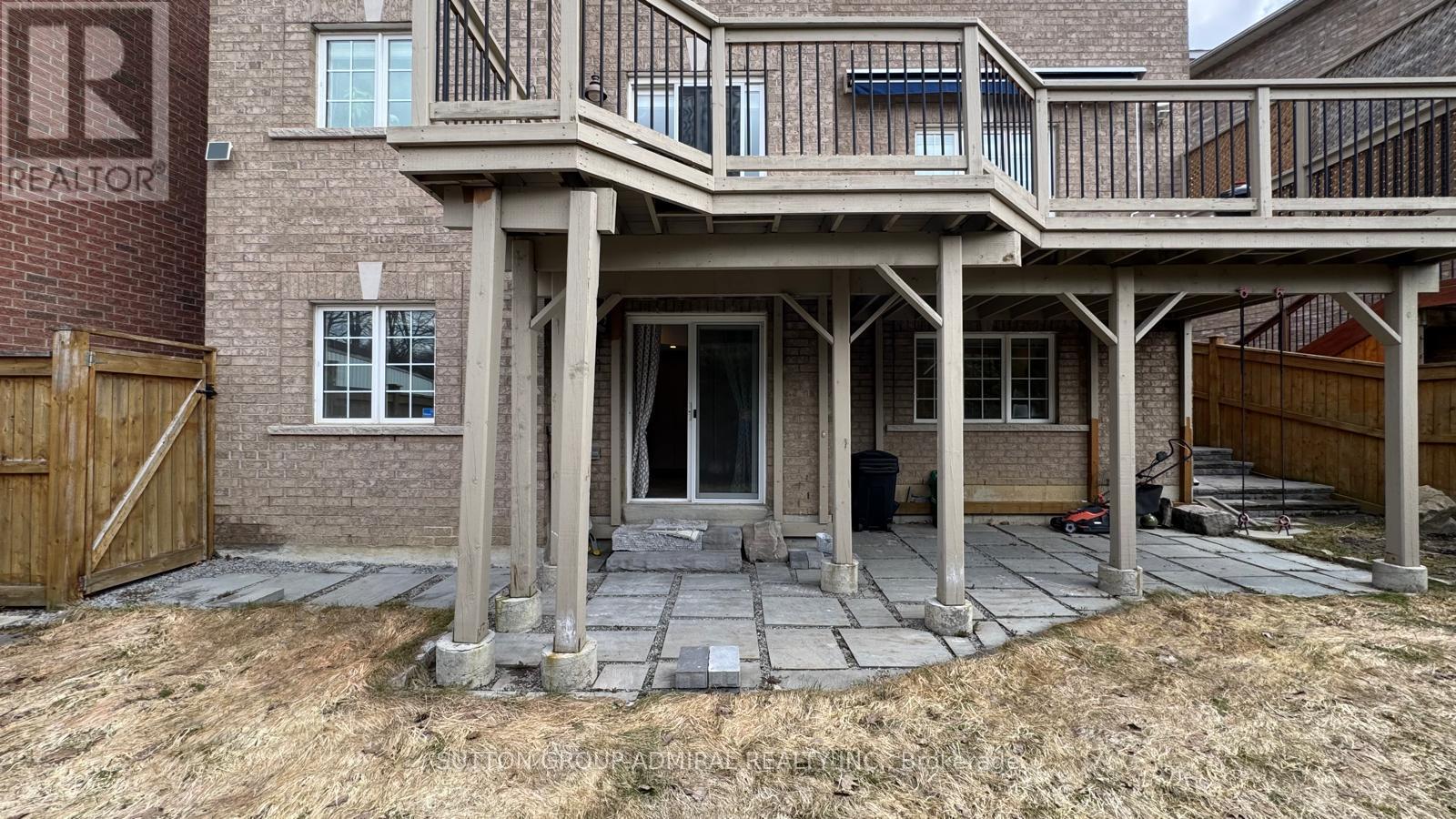 A house with a balcony and a sign that says "REALTOR" on the wall.