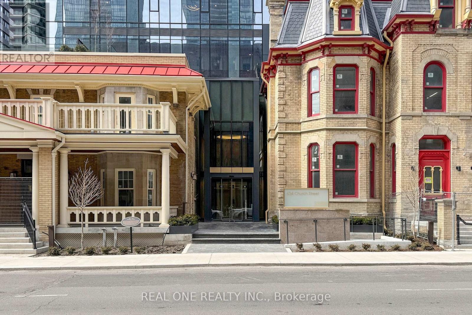 A building with a red roof and a sign that says "REALTOR" in front of it.