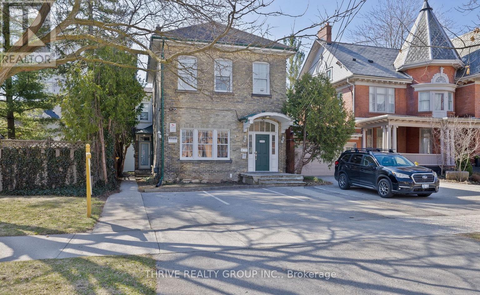 A house with a car parked in front of it.