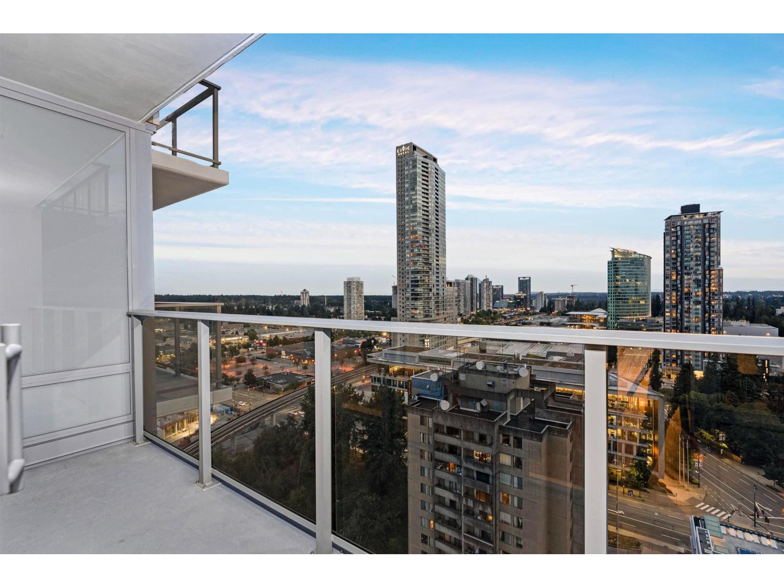 A balcony overlooks a cityscape with tall buildings.