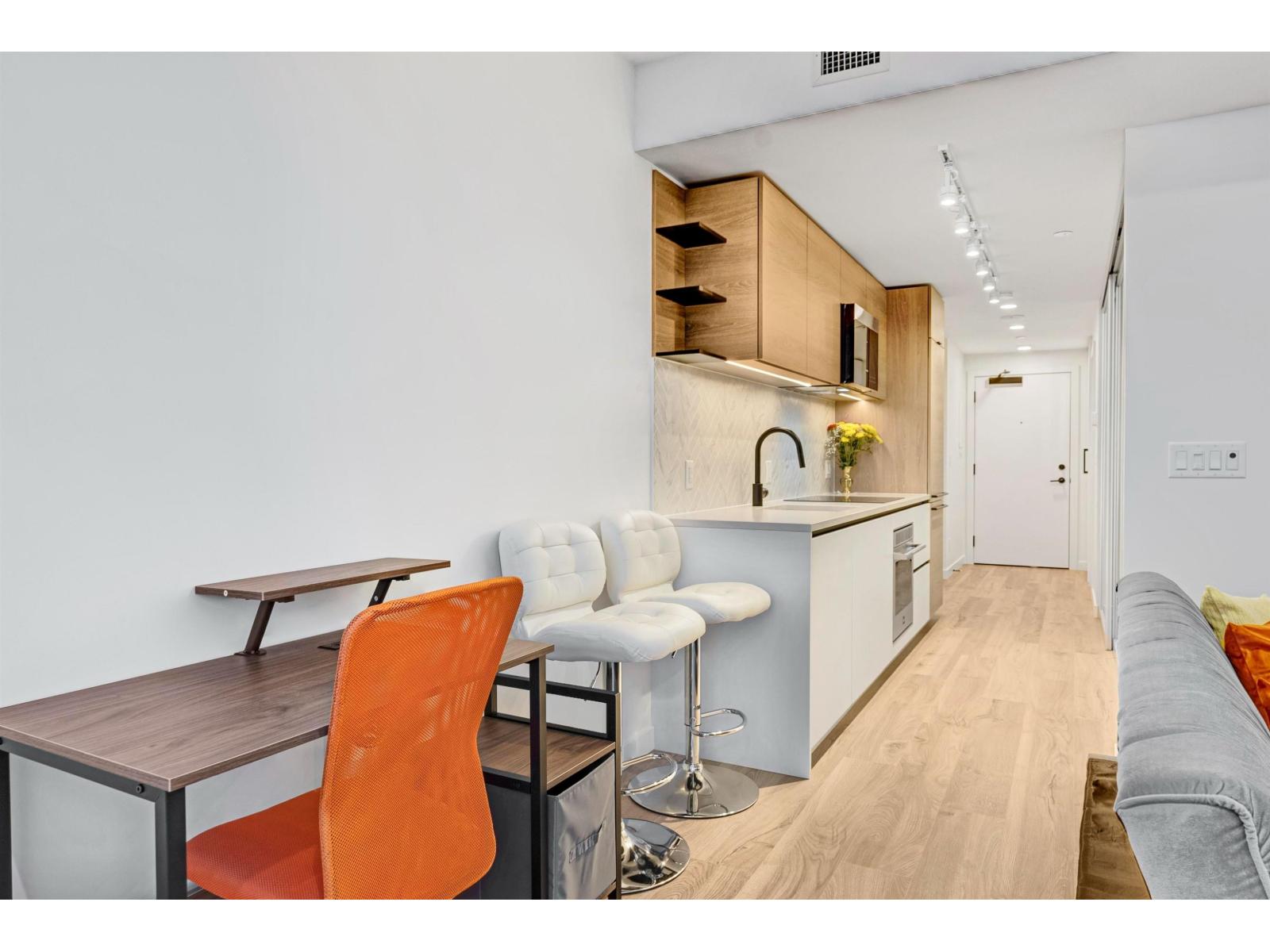 A modern kitchen with a dining table and chairs.