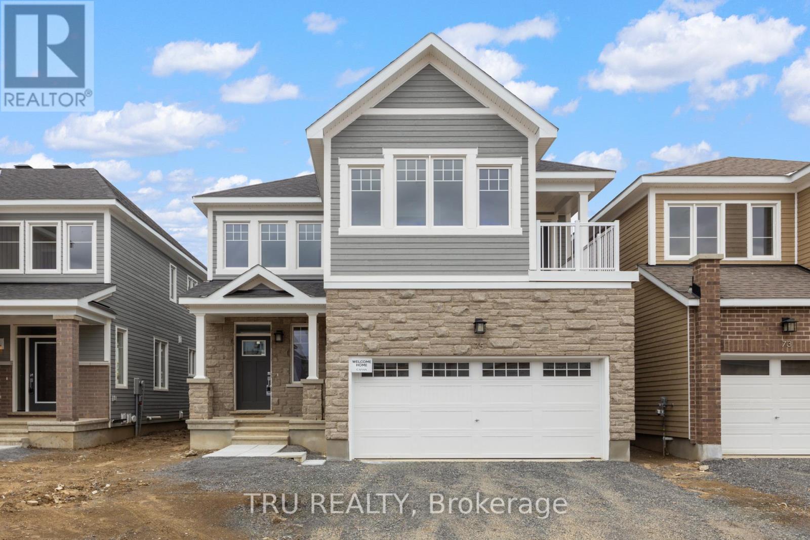 A row of houses with the text "TRU REALTY, Brokerage" in the foreground.