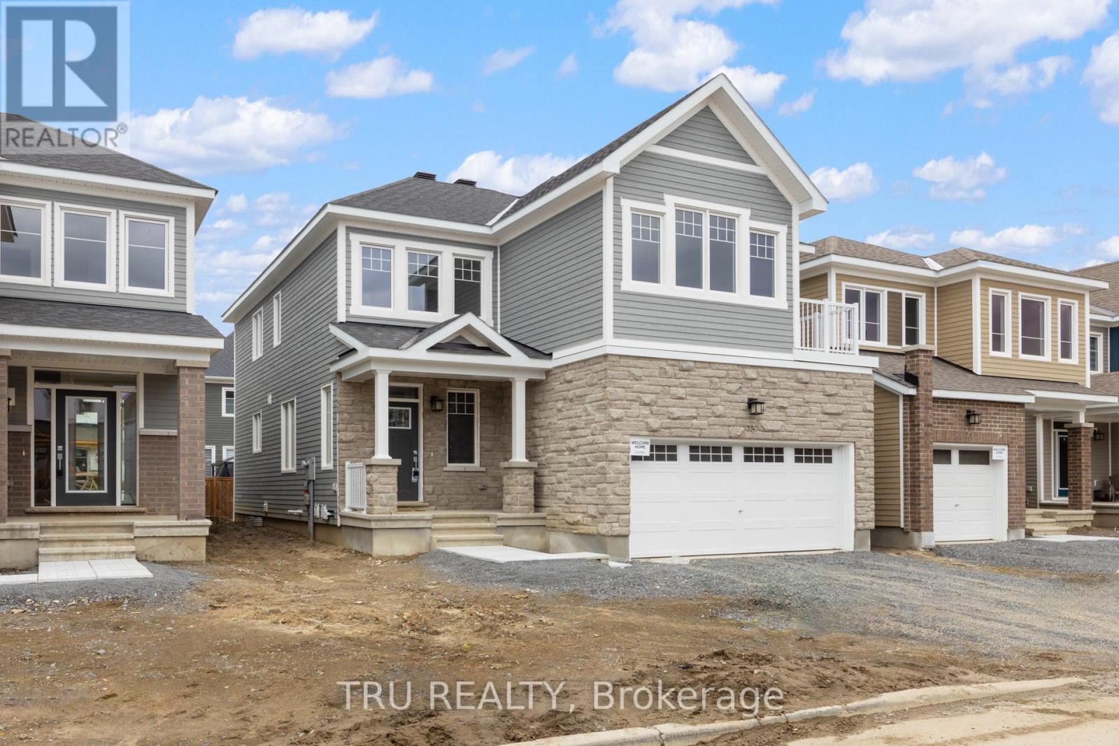 A row of new houses are being built by TRU REALTY Brokerage.