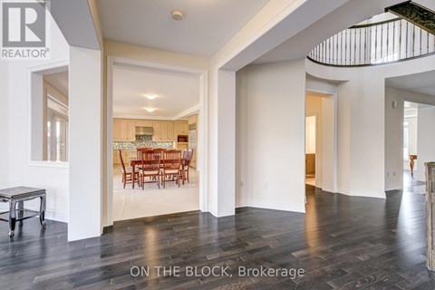 A dining room with a table and chairs is visible through a glass door.