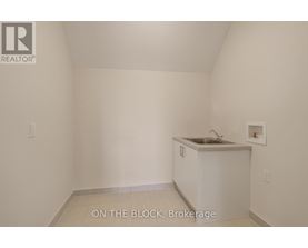 A small white kitchen with a sink and a cabinet.