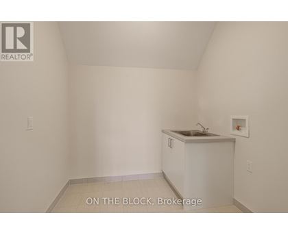 A small white kitchen with a sink and a cabinet.