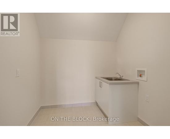 A small white kitchen with a sink and a cabinet.