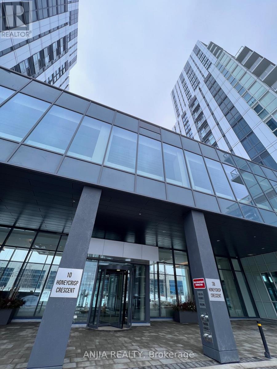 The entrance to a building with a glass facade and a sign that reads "10 Honeycreek Crescent".