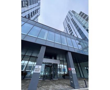 The entrance to a building with a glass facade and a sign that reads "10 Honeycreek Crescent".
