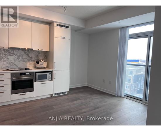 A kitchen with white cabinets and a marble backsplash is shown in the image.