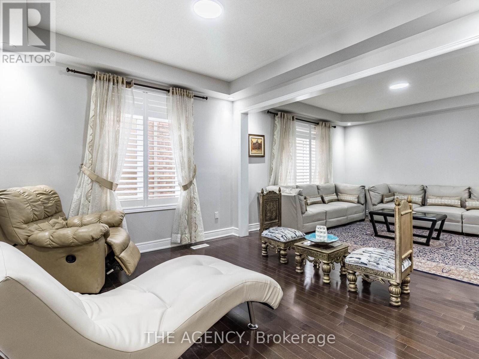 A well-lit living room with a white sofa and a wooden coffee table.
