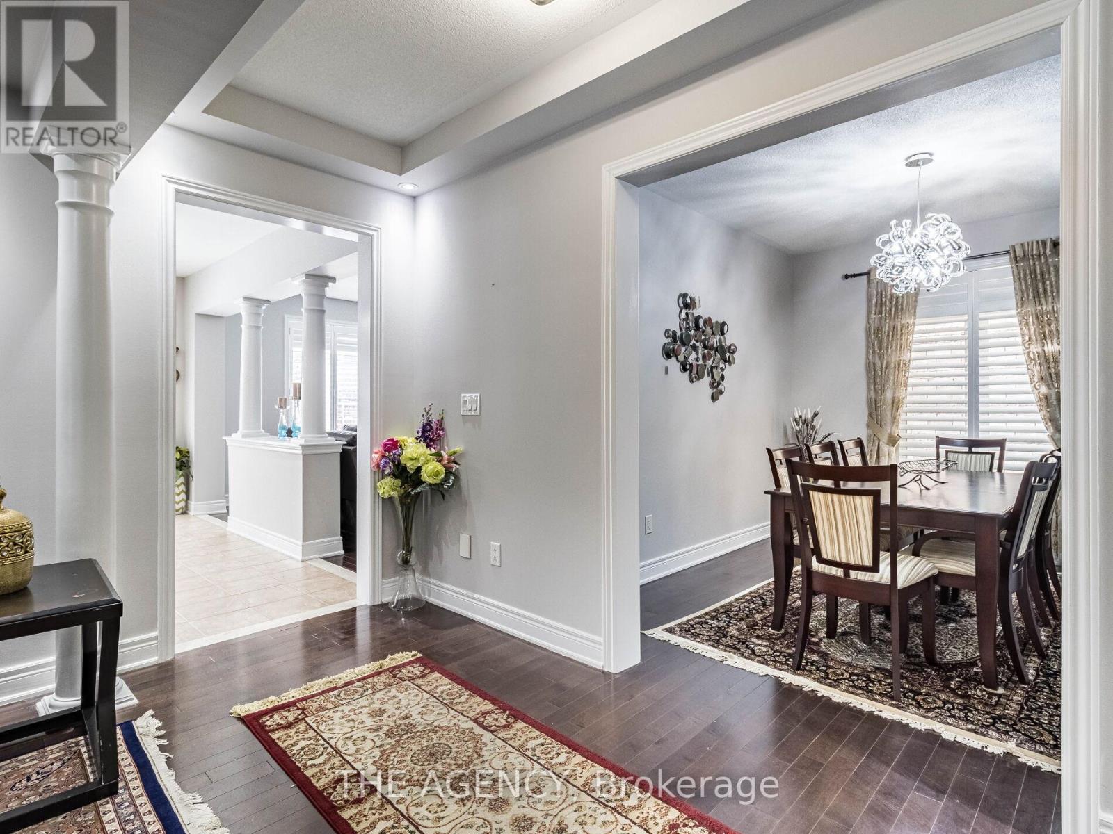 A dining room with a table set for four.