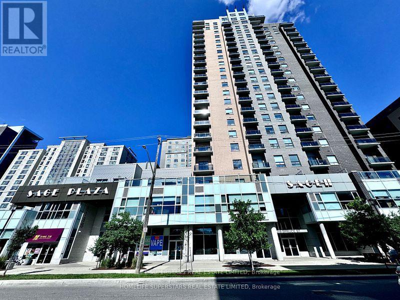 A tall building with a glass facade is the centerpiece of a city street scene.