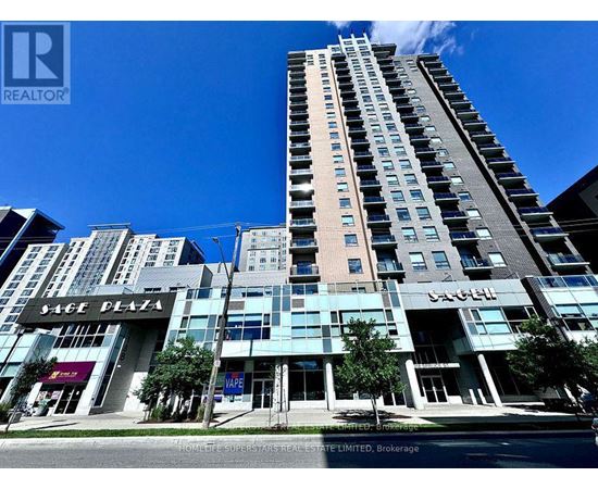 A tall building with a glass facade is the centerpiece of a city street scene.