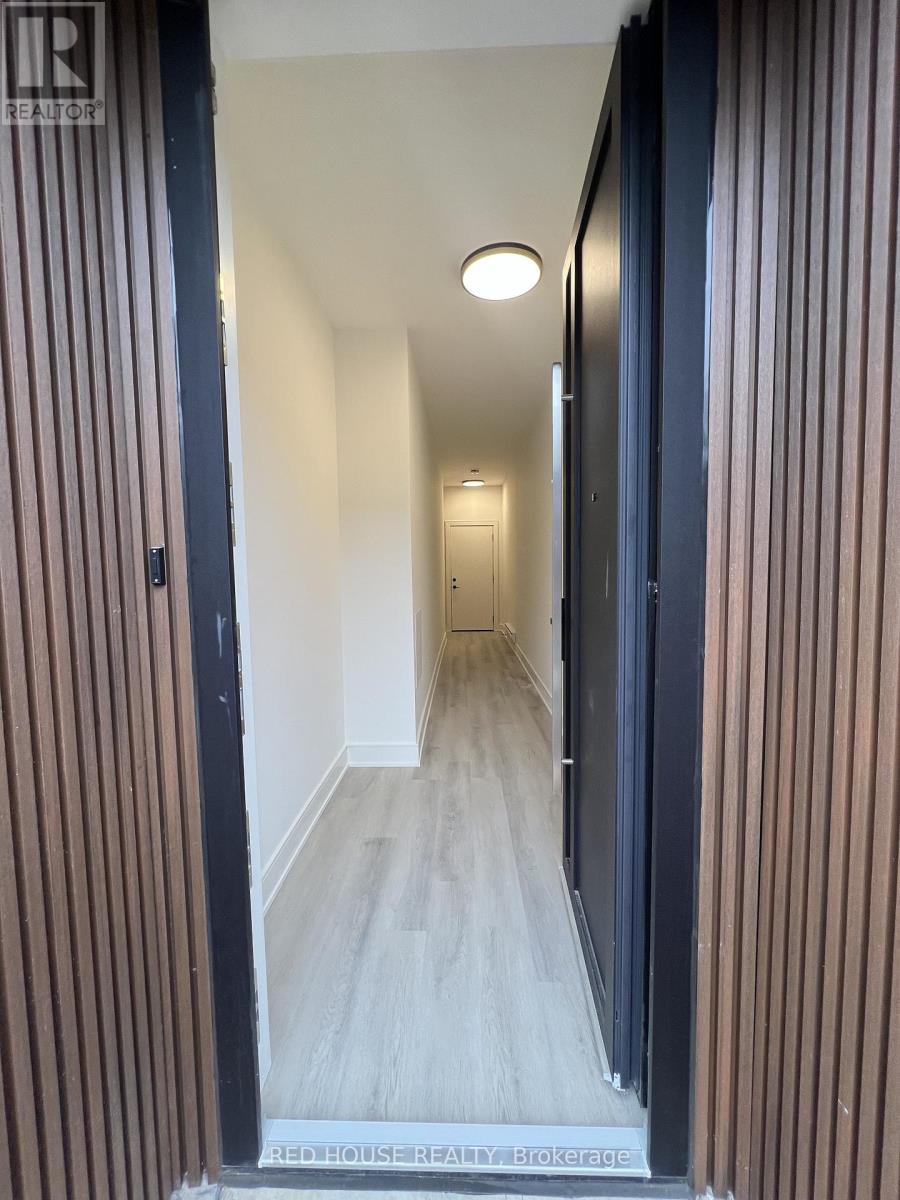 A hallway with a wooden floor and striped walls.