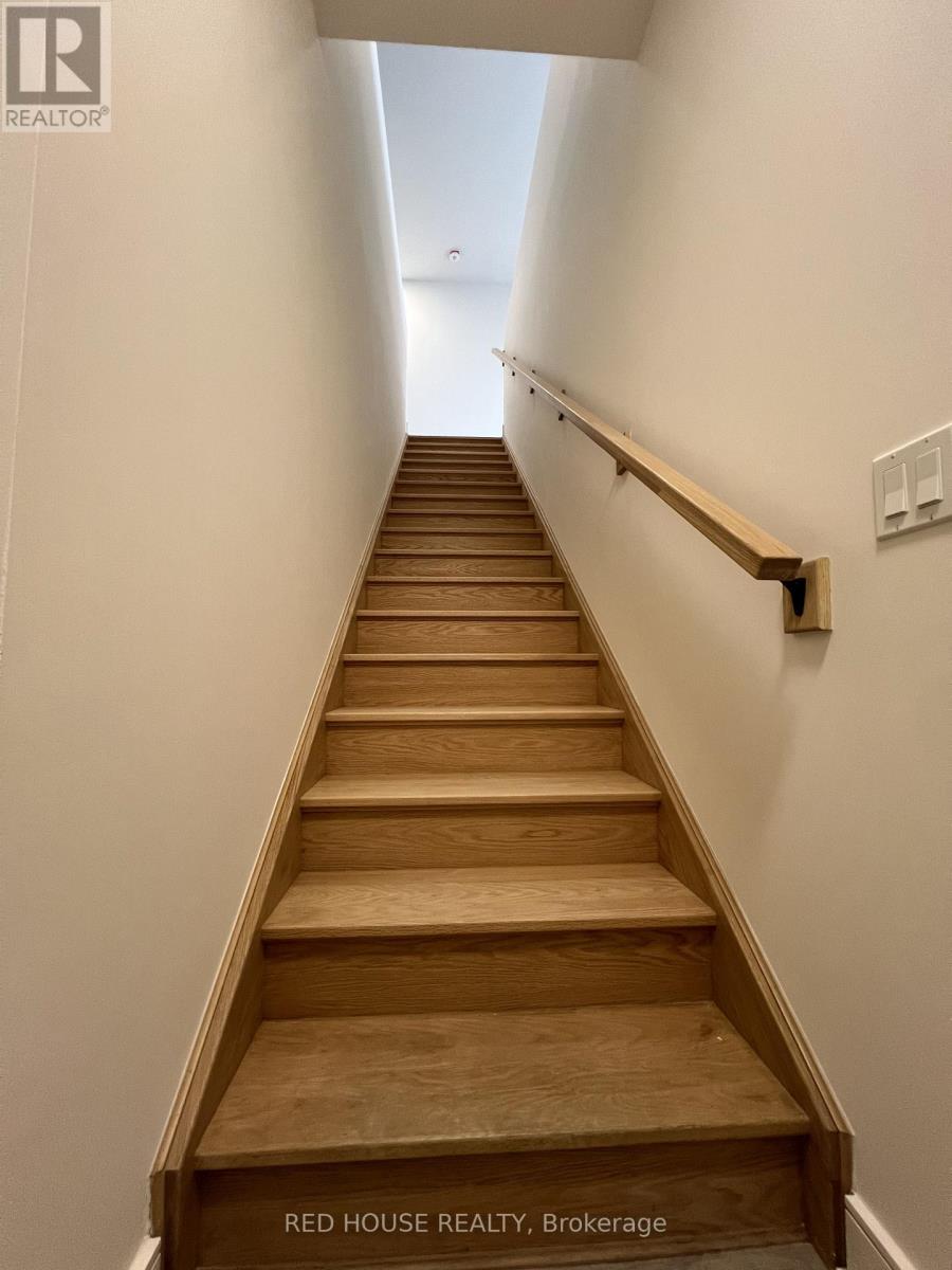 A staircase with wooden steps and a handrail.