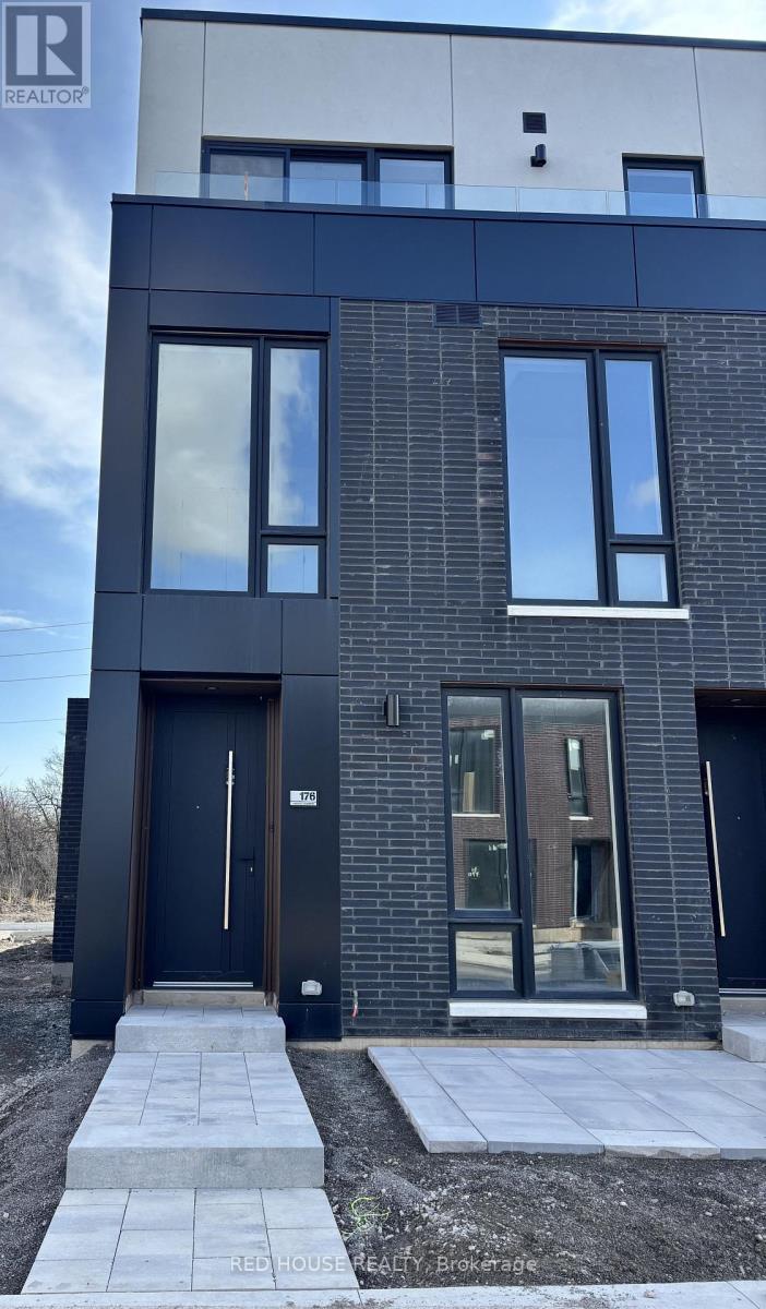 A modern house with a black front door and windows.
