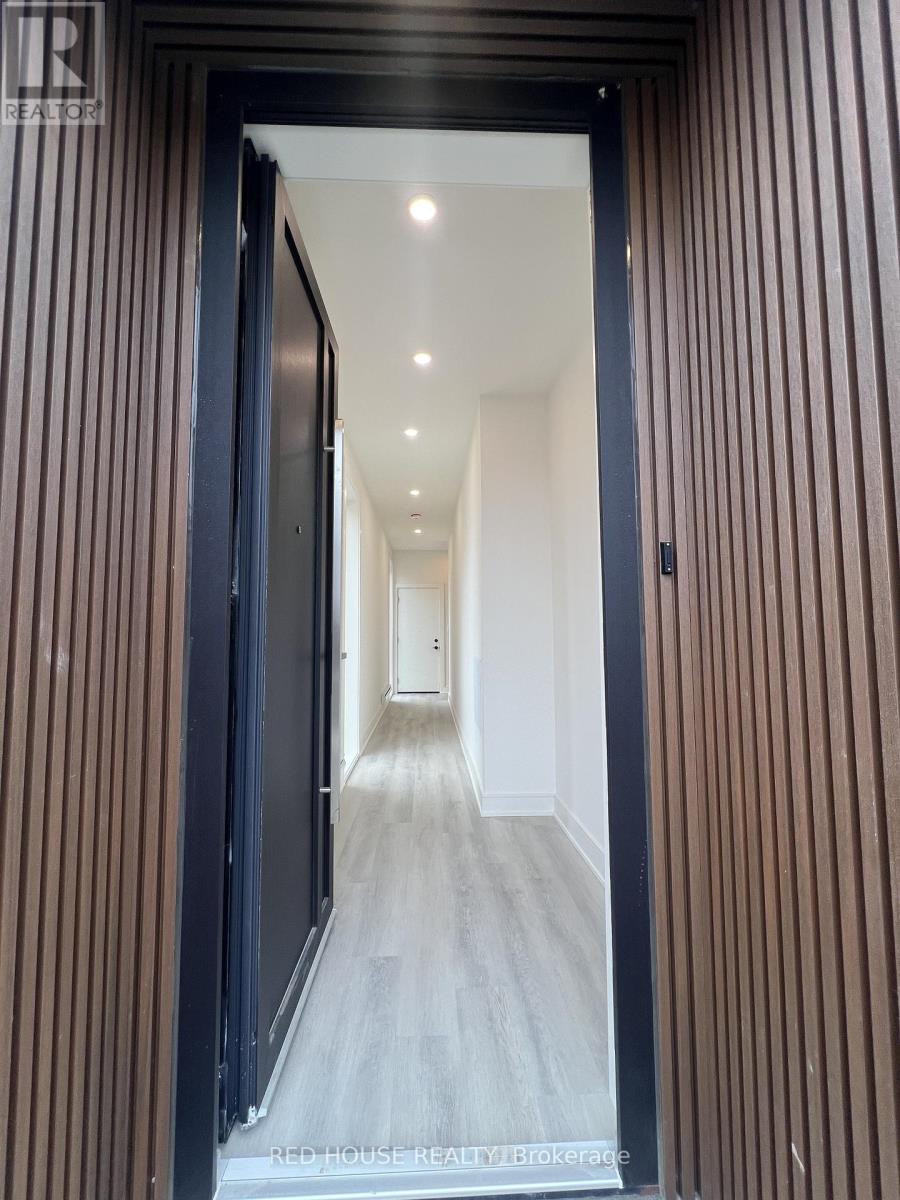 A hallway with a black door and striped walls.