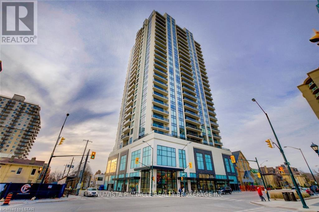 A tall building with a glass facade is the main focus of the image.
