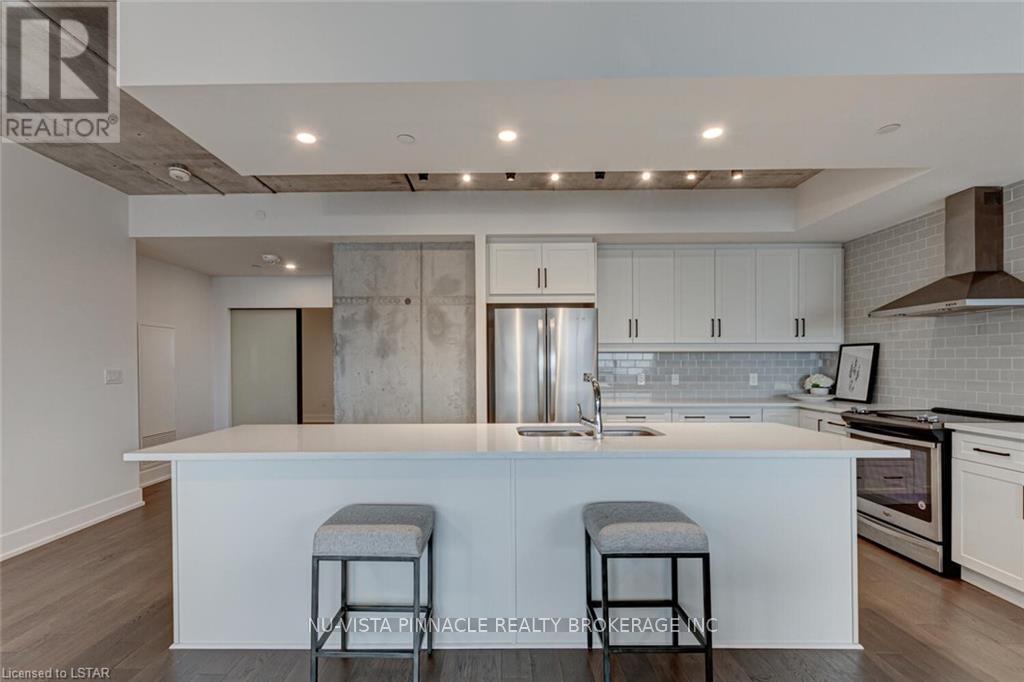A modern kitchen with white cabinets and a central island.
