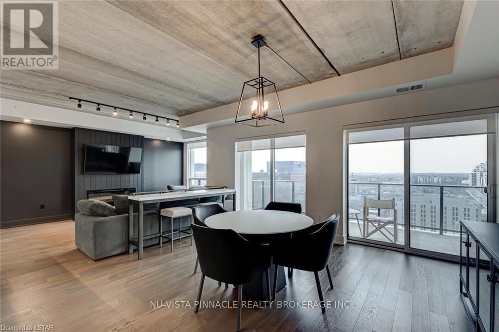 A modern living room with a dining table and chairs.