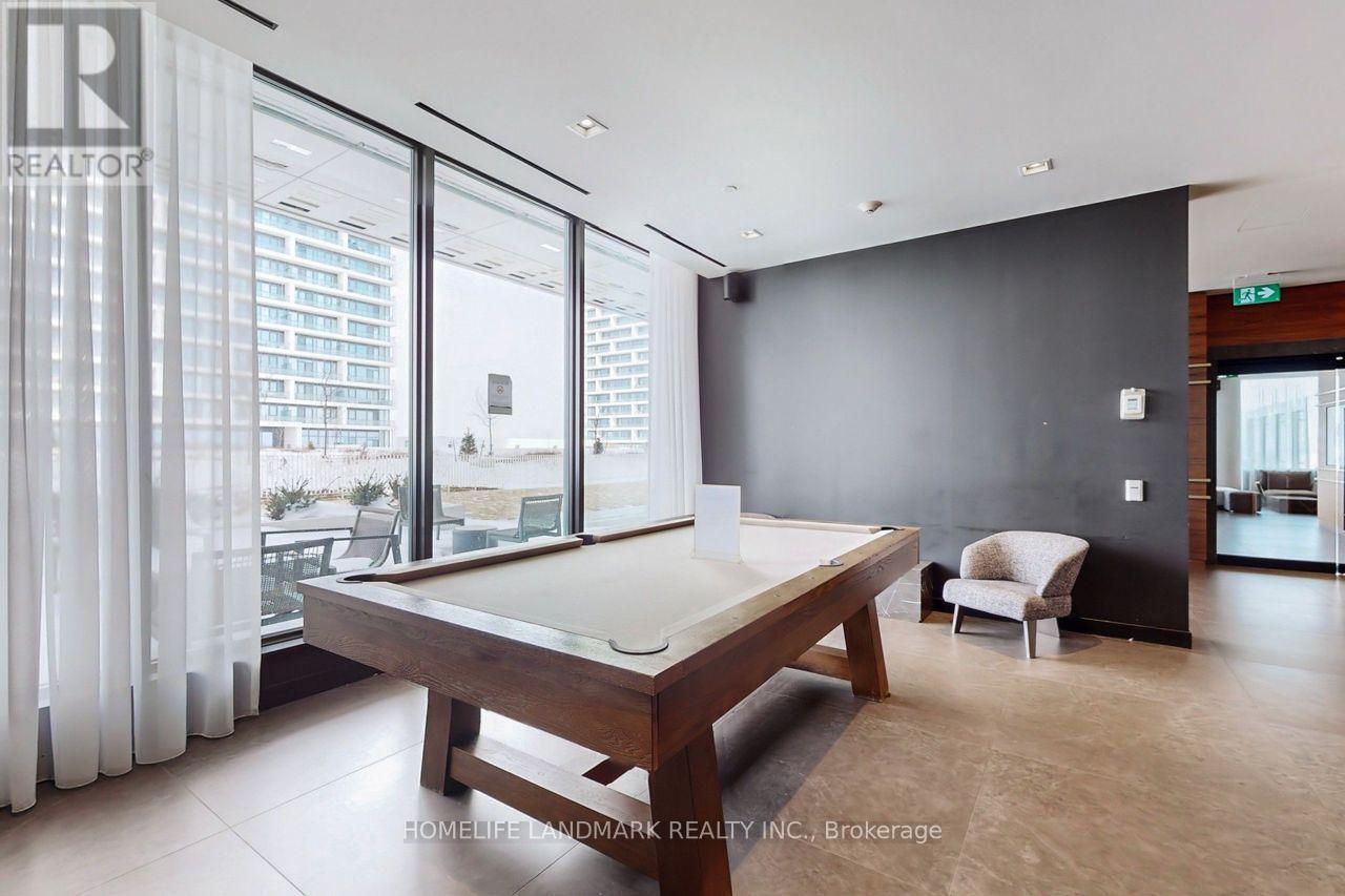 A room with a pool table and a chair.
