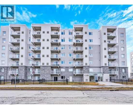 A large apartment building with a sign that says REALTOR.
