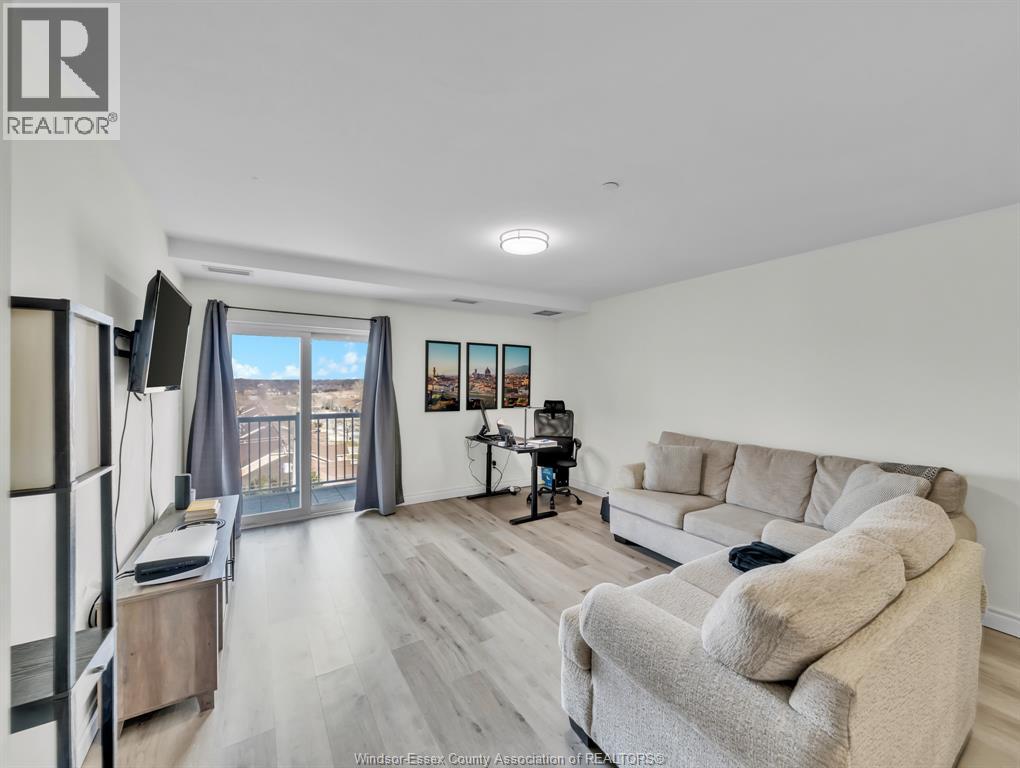 A living room with a grey couch and a television.