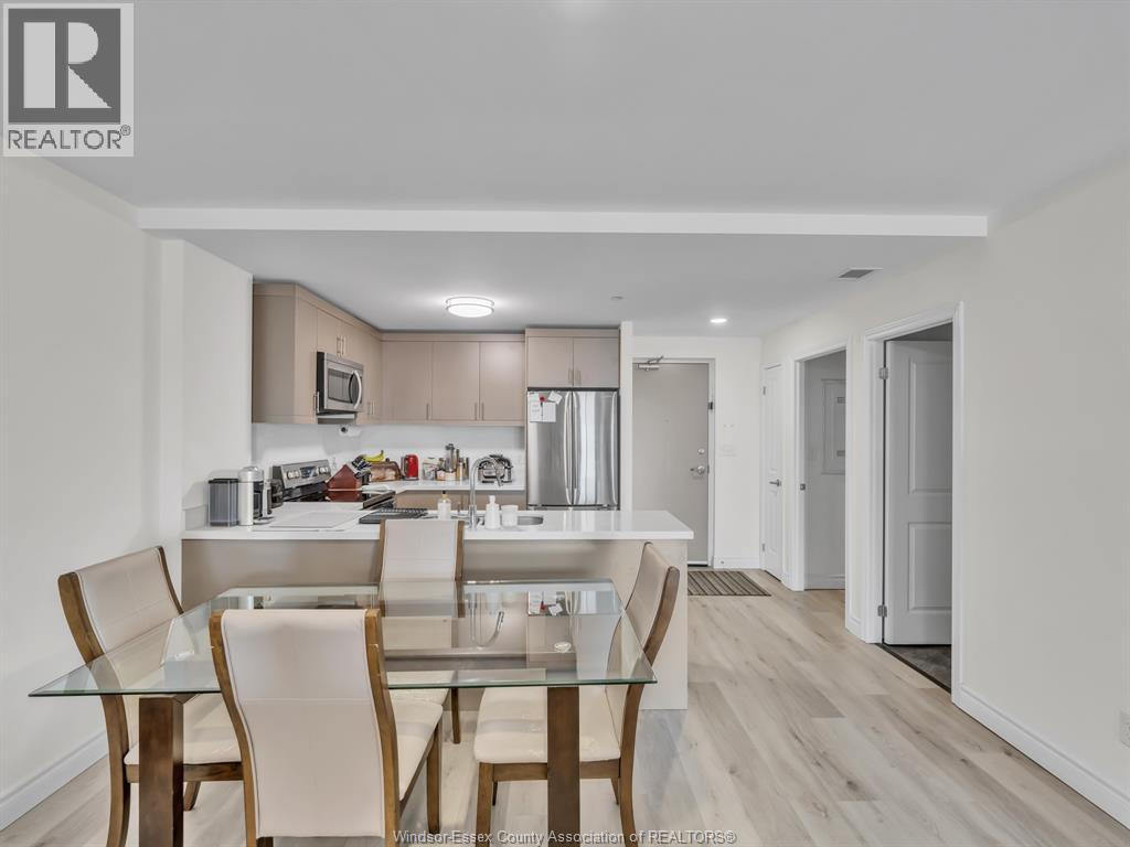 A modern kitchen with a glass table and chairs.