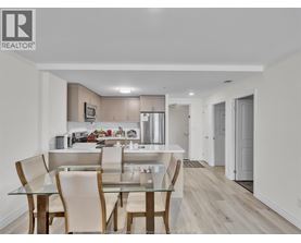 A modern kitchen with a glass table and chairs.