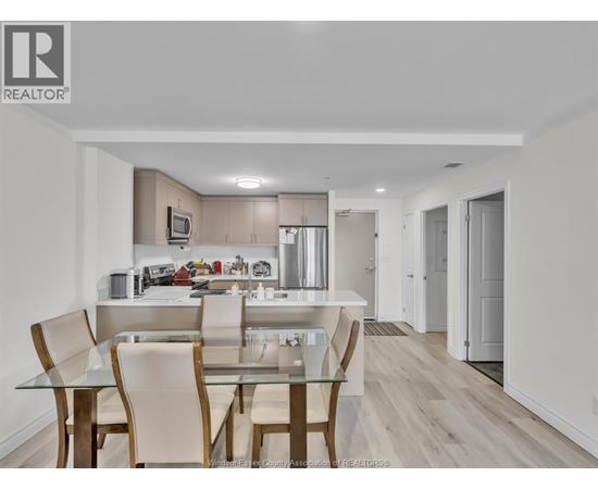A modern kitchen with a glass table and chairs.