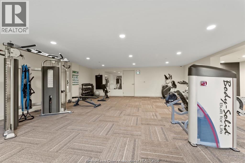 A gym room with a variety of equipment including a treadmill, weights, and a bench press.