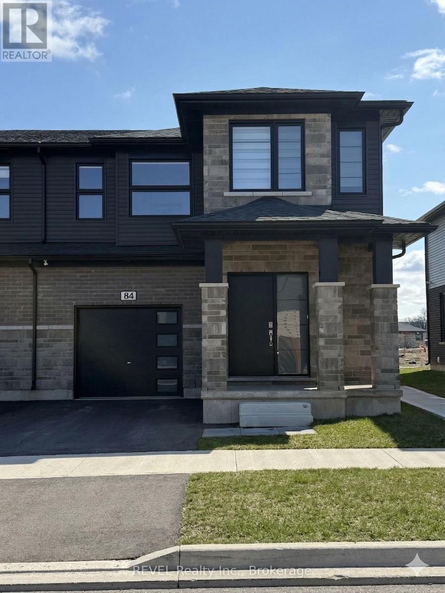 A modern house with a black front door and windows.