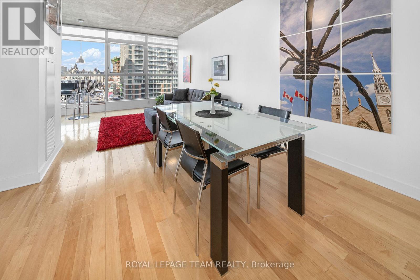 A dining room with a glass table and chairs.