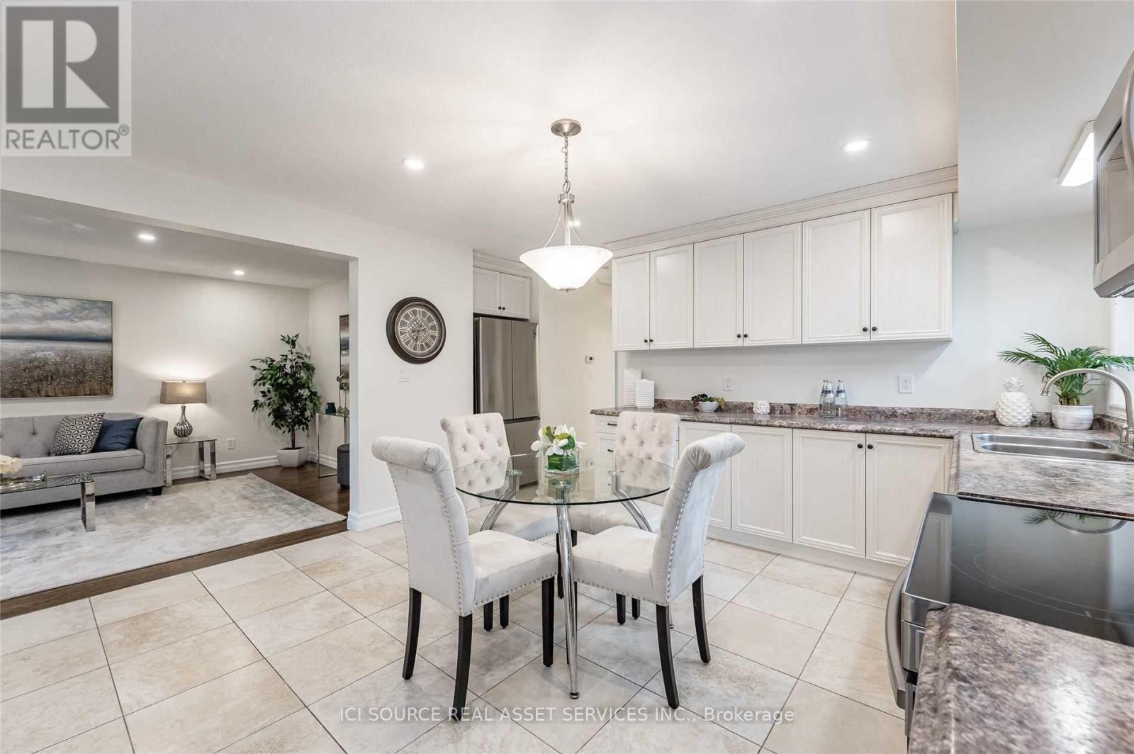 A modern kitchen with a glass table and chairs.