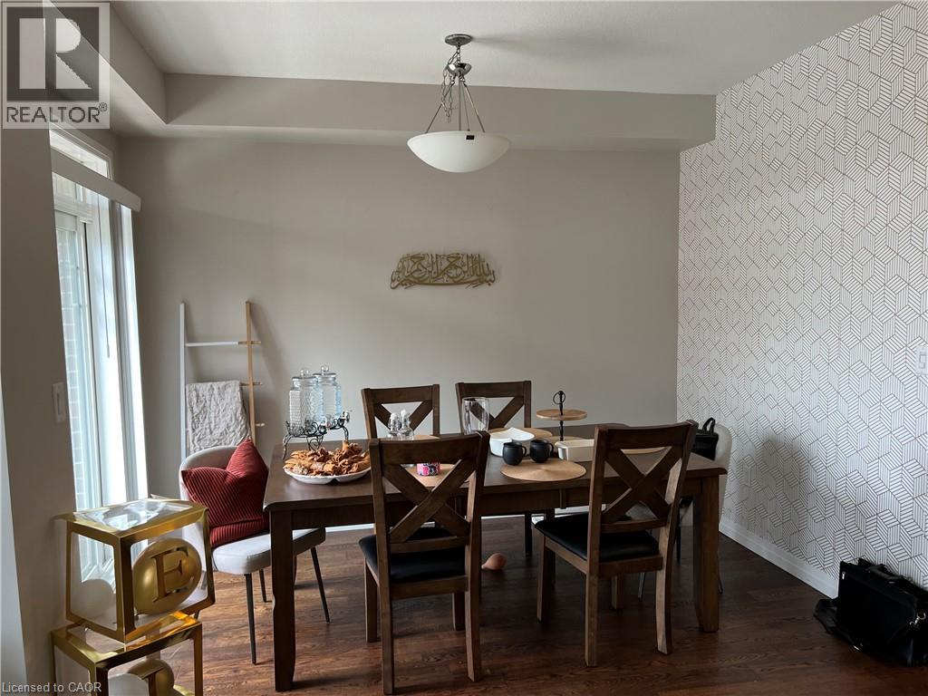 A dining room with a table set for four.