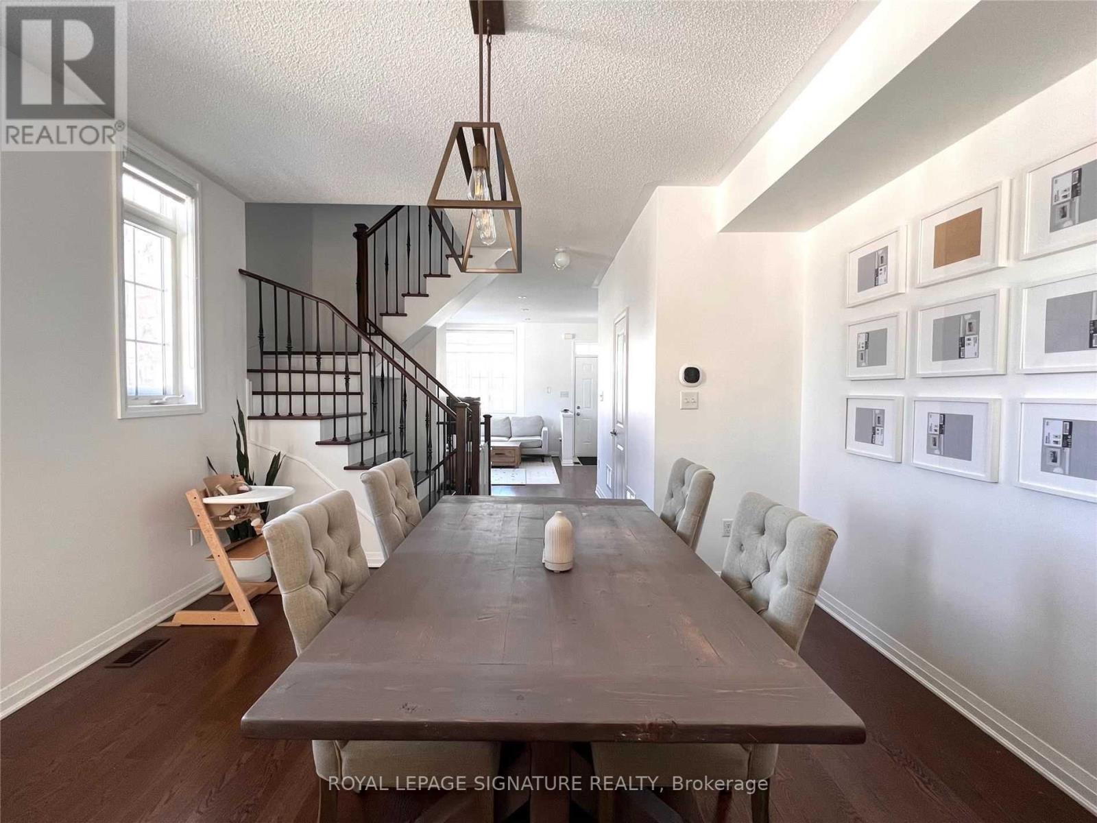 A dining room with a long table and chairs.