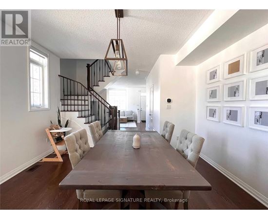 A dining room with a long table and chairs.