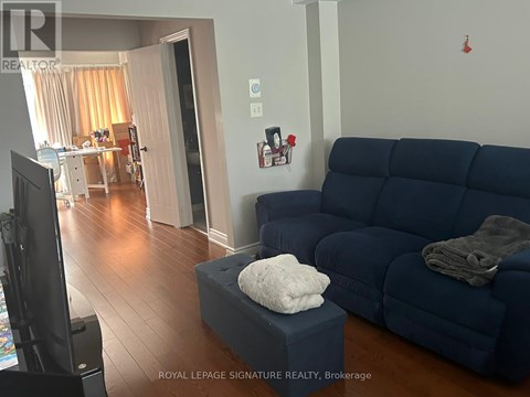 A living room with a blue couch and a television.