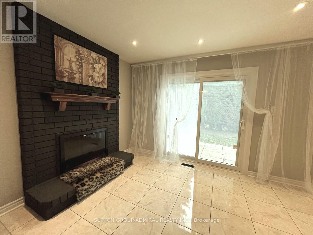 A living room with a fireplace and sliding glass doors.