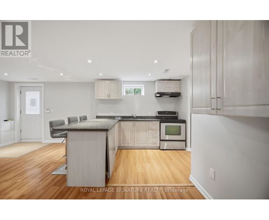 A kitchen with wooden floors and white walls.