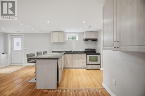 A kitchen with wooden floors and white walls.