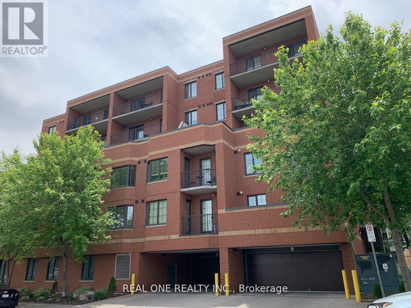 A multi-story apartment building with a parking garage at the bottom.