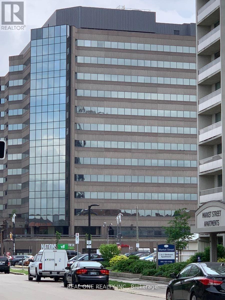 A tall building with a glass facade is in the background.