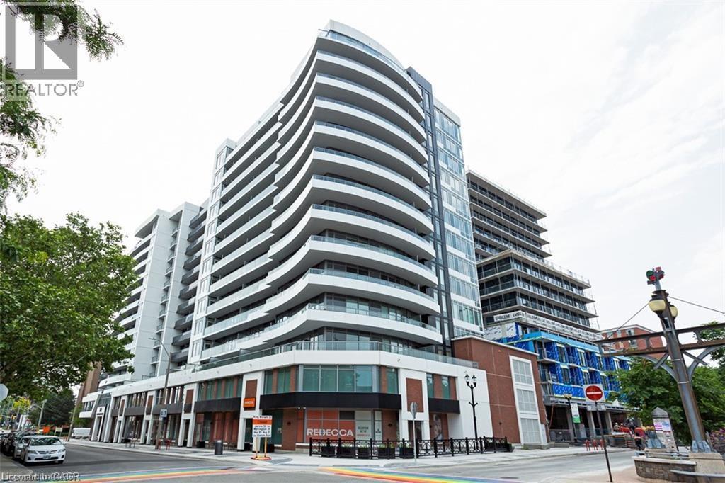A tall, modern building with a curved design is the focal point of the image.