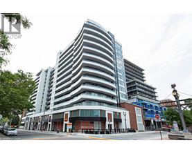 A tall, modern building with a curved design is the focal point of the image.