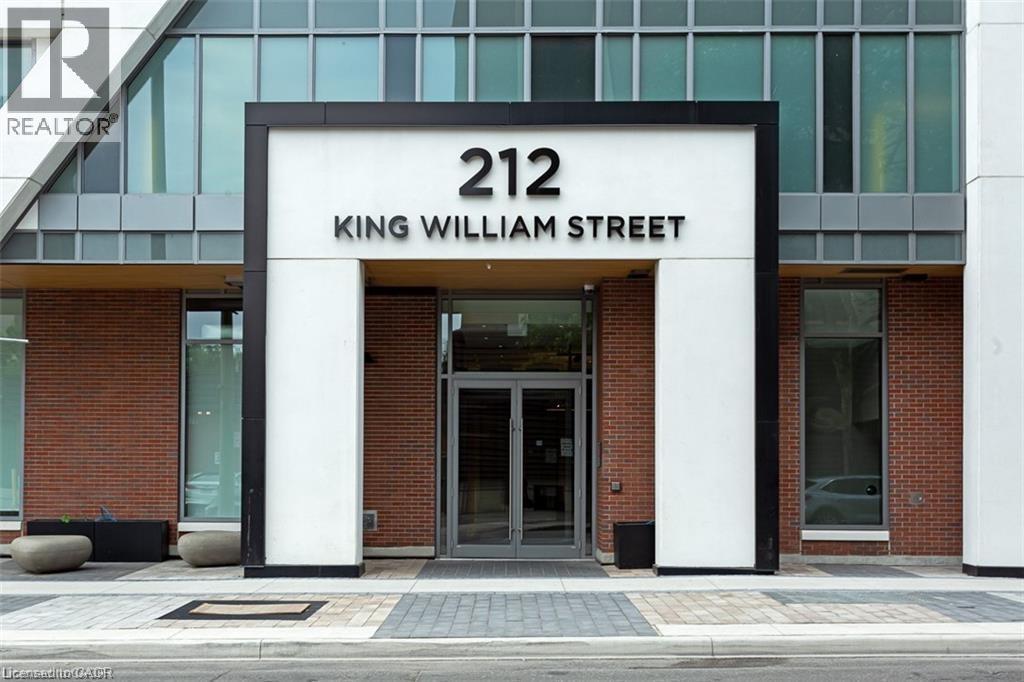The front of a building with a glass facade and a sign that reads "212 King William Street.".