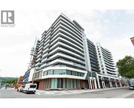 A modern multi-story building with a glass facade is under construction.